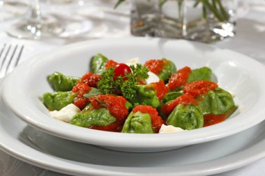 Artichoke pasta with tomato and basil sauce on a plate