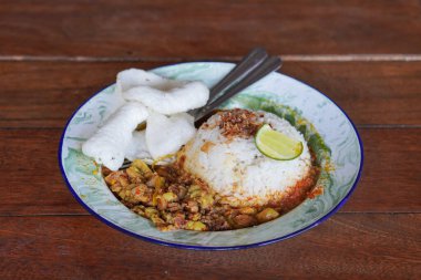 Gultik, Endonezya, 18 Temmuz 2025 'te yakalandı. Küçük pirinç porsiyonu sığır gülü, zengin hindistan cevizi körisi ve sambal, popüler Jakarta sokak yemekleri.