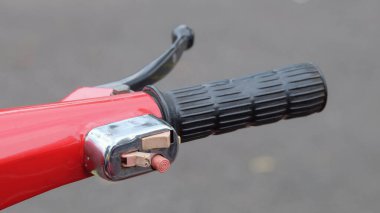 Handlebars and holders on classic scooters. Red classic scooter. The handlebars and gas handle rubber are worn black rubber. The lamp holder and horn look vintage clipart