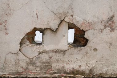 Delikleri olan eski bir duvar. Beton duvarlar eski ve grunge 'a benziyor. Grafik tasarımı veya afiş arkaplanı için
