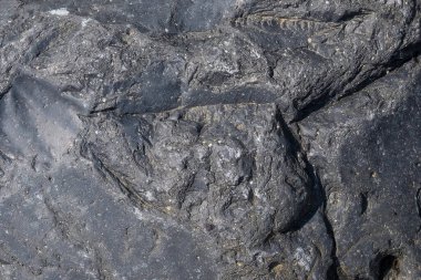 Gri taş yüzeyin soyut desen ve doku arkaplanı. Grafik tasarımı veya afiş arkaplanı için