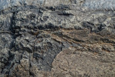 Gri taş yüzeyin soyut desen ve doku arkaplanı. Grafik tasarımı veya afiş arkaplanı için