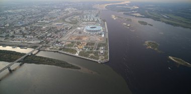 City with a river running through it. The river is brown and the city is full of buildings. Nizhny Novgorod clipart