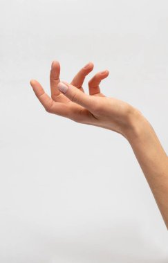 Zarif bir el açık avuçla temiz beyaz arka plana uzanıyor. Yakın plan fotoğraf makro görüntüsü.