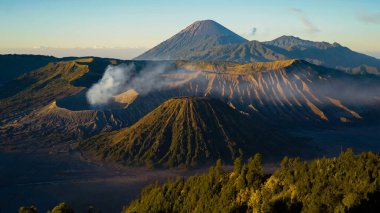 Bromo Dağı 'nda çarpıcı bir gündoğumu canlı bir günbatımını gözler önüne seriyor. Bulutlar zirveyi zarifçe kaplıyor ve Doğu Java' nın doğal güzelliğini gözler önüne seriyor..