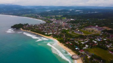 Hindistan cevizi palmiyeleri, turkuaz okyanus dalgaları ve Endonezya ile çarpıcı tropikal plajların havadan görünüşü