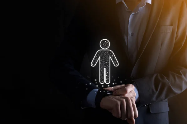 Businessman holds man person icon on dark tone background.HR Human ,people iconTechnology Process System Business with Recruitment, Hiring, Team Building. Organisation structure concept.