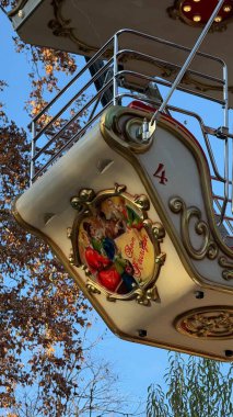 Vintage Christmas Carousel at Vienna Rathausplatz. A close-up view of a beautifully decorated vintage carousel cabin at the Christmas market in Rathausplatz, Vienna. The retro design features clipart