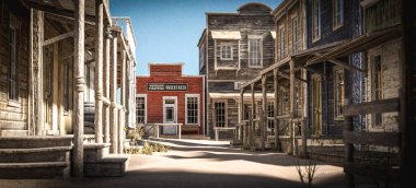 3D illustration rendering of an empty street in an old wild west town with wooden buildings.
