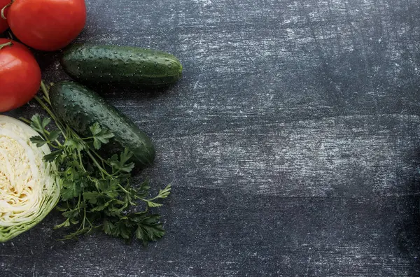 Siyah arka planda taze sebzeler, baharatlar ve domateslerin üst görüntüsü