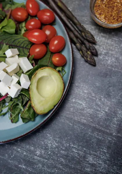 Tahta bir masada taze sebze ve peynir tabağı.