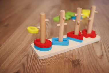 Childs 'ın elleri ahşap Montessori ayıklama oyuncağına şekil veriyor. Bebekler için renkli eğitim oyuncağı, iyi motor becerileri, koordinasyonu ve bilişsel gelişimi teşvik ediyor.