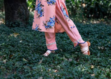 A woman wearing floral design sandals clipart