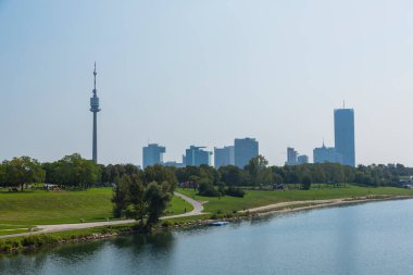 The Danube River and the Danube Tower flowing through Vienna, the capital of Austria clipart