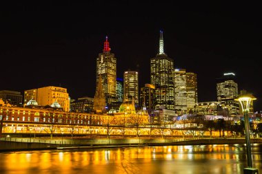 Night view of Flinders Street Station and along the Yara River in Melbourne, Australia clipart