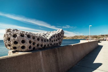 Bodo, Norway - 12 Aug 2018: Unique perforated rock structure on the waterfront walkway at Bodo, Lofoten during the day clipart