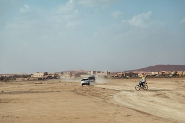 Countryside, Morocco, July 23th 2019: Exploring the dusty landscapes of Morocco with vehicles on a hot, sunny day clipart