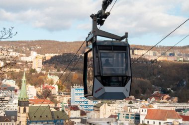 Cable car cabin Vetruse over blue sky with clouds. Cableway, green transportation.  clipart