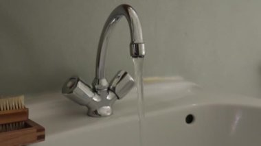 Tuvalet Musluğu / Musluğu çalışıyor. Kamera bir dolly / Tracking Shot 'a yaklaşıyor