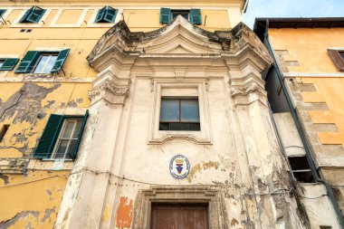 Civitavecchia, Italy - Nov 13, 2024: A close-up of a historic facade with weathered walls and classical details in Piazza Leandra clipart