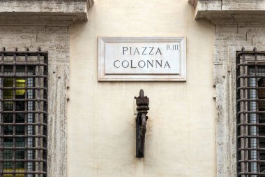 Plaque indicating Piazza Colonna on the facade of Palazzo Chigi in Rome, Italy clipart