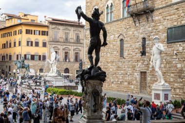 Floransa, İtalya - 10 Mayıs 2025: Turistler, Perseus, David ve Neptün Çeşmesi de dahil olmak üzere Piazza della Signoria 'daki heykellerin etrafında toplandılar