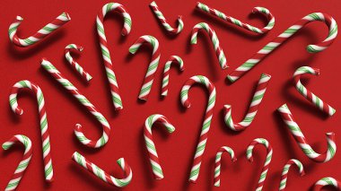 Şeker kamışları kırmızı arka planda sıralanmış. Noel şeker kamışları. Üst Görünüm Noel Kompozisyonu.