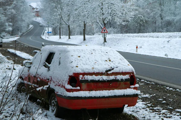 Abandoned car standing by the road. Maybe after the traffic accident or failure. Symbolises also the dangerous conditions in winter with ice and snow.