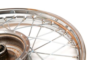 The shiny chrome rim from the old veteran motorbike with lacing. Isolated in a white background.