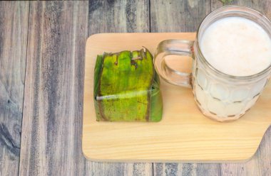 Breakfast menu consists of a glass of cereal milk and white sticky rice tape snacks clipart