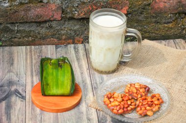 Village food menu consisting of a glass of milk, emping snacks and white sticky rice tape clipart