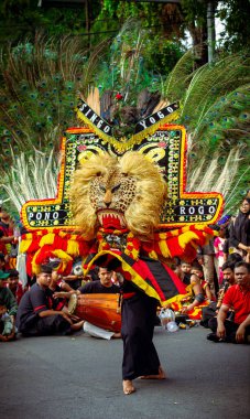 Indonesia, Solo - December 23, 2024: Traditional Reog Ponorogo dance performance on Slamet Riyadi Street clipart