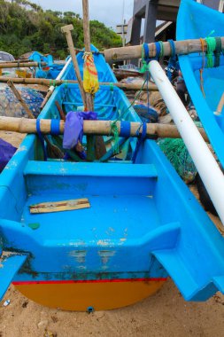 Indonesia, Yogyakarta - January 12, 2025: Fishing boat stranded on Drini beach, a boat usually used to catch fish in the open sea. clipart