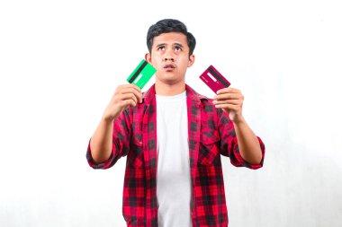 Kareli tişört giyen Asyalı bir adam beyaz arka planda izole edilmiş bir kafa karışıklığının kredi kartı ifadesini taşıyor.