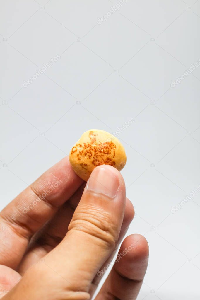Indonesia,Sukoharjo -March 31,2025 : man's hand holding hello panda snack product with white background
