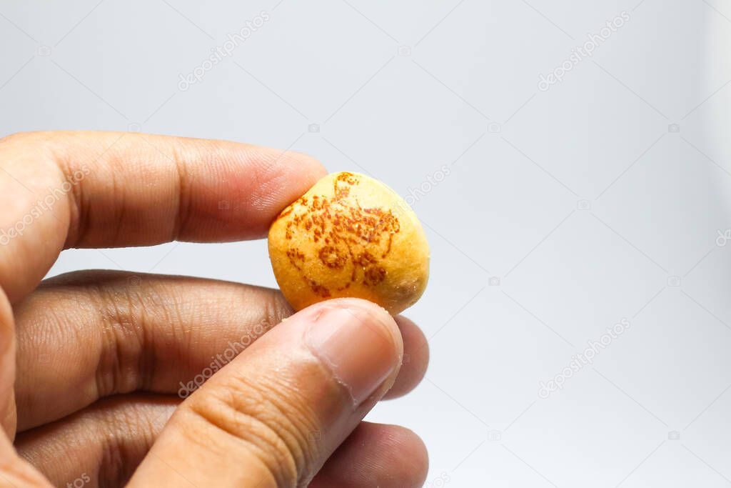 Indonesia,Sukoharjo -March 31,2025 : man's hand holding hello panda snack product with white background