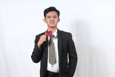 Asyalı iş adamı gülümsemesi beyaz arka planda izole edilmiş kredi kartı gösteriyor