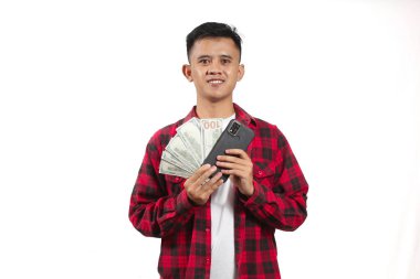 Elinde akıllı telefon ve bir sürü dolar tutan Asyalı bir adam.