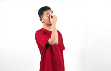 Asyalı adamın başı dönüyor ve gözleri bulanık beyaz arka planda izole edilmiş.