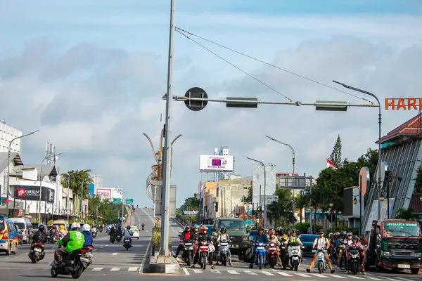 Endonezya, Solo - 1 Haziran 2025: Bir grup motosikletçi kırmızı ışık yandığında durmak için kurallara uyarlar.