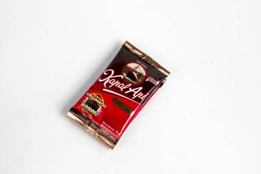 Indonesia, Sukoharjo - June 19, 2025 : black coffee sachets brand  steamer (Kapal Api) product from Indonesia, isolated on white background