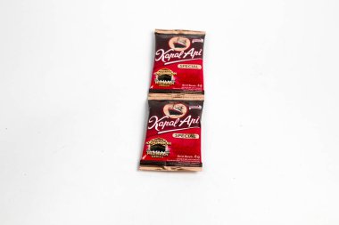 Indonesia, Sukoharjo - June 19, 2025 : black coffee sachets brand  steamer (Kapal Api) product from Indonesia, isolated on white background