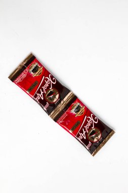 Indonesia, Sukoharjo - June 19, 2025 : black coffee sachets brand  steamer (Kapal Api) product from Indonesia, isolated on white background