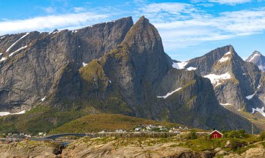 Hamny Village, Lofoten Adaları, Hamnya, Moskenesya, Norveç. Renkli evleri olan dağların güzel manzarası İskandinavya 'ya özgü ve Kuzey Kutup Dairesi' ndeki botlar.