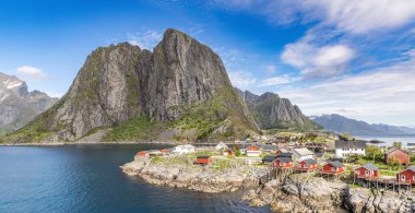 Hamny Village, Lofoten Adaları, Hamnya, Moskenesya, Norveç. Renkli evleri olan dağların güzel manzarası İskandinavya 'ya özgü ve Kuzey Kutup Dairesi' ndeki botlar.