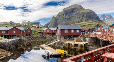 Srvgen Köyü, Lofoten Adaları, Moskenesya, Norveç. İskandinavya 'nın tipik kırmızı evleri olan dağların güzel manzarası