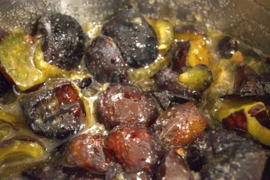 Ev yapımı erik reçeli. Metal tencerede kaynıyor. Geleneksel tatlı için yakın plan hazırlanıyor..