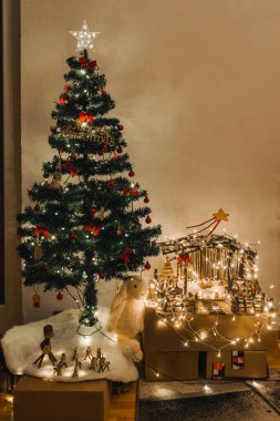 El yapımı Tahta Noel İsa 'nın Doğumu Sahnesi Işıklar ve Çam Ağacı Festivali Dekoru ve Sıcak Dilekler. Yüksek kalite fotoğraf