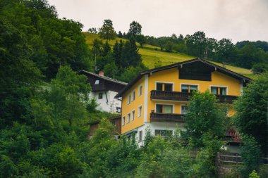 Scenic countryside view featuring traditional buildings surrounded by lush greenery in a tranquil rural setting Konigssee Bavaria German Apls. High quality photo clipart