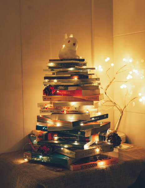 Christmas Tree with Book and Nativity Scene Festive Holiday Decorations and Cozy Seasonal Atmosphere. High quality photo